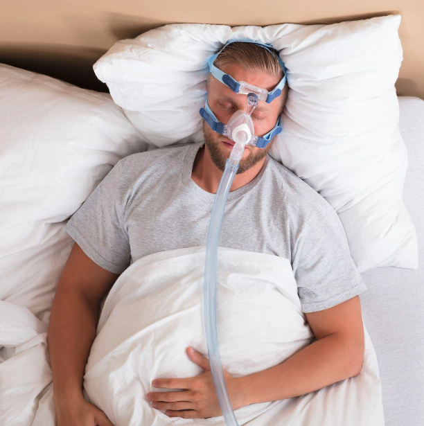 Image of adult male using CPAP Machine for Sleep Apnea